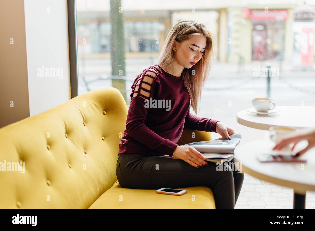 Young girl sit with cup of coffee and smile to the camera Stock Photo ...