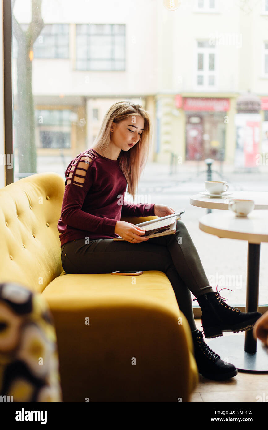Young girl sit with cup of coffee and smile to the camera Stock Photo ...