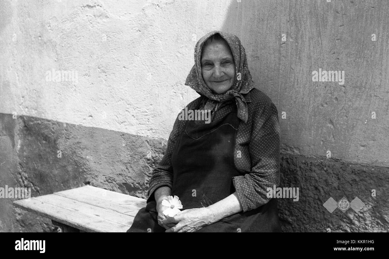A photograph from 1960 of 92-year-old Marija Podlogar during a holiday celebration, reflecting the cultural practices and traditions of the time. The image captures a milestone moment in her life. Stock Photo