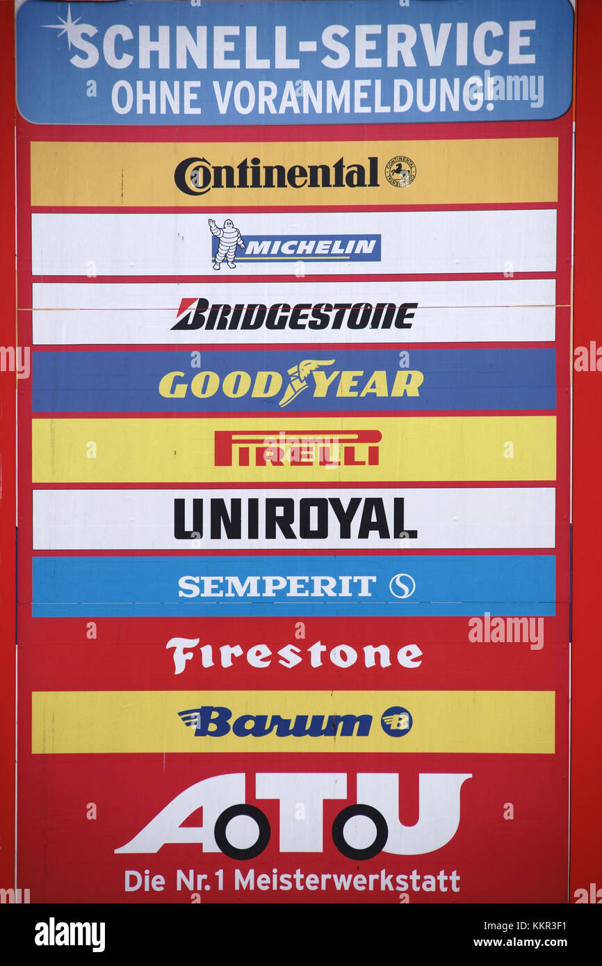 The company sign of the repair garage ATU with the logos of  different tyre producers. Stock Photo