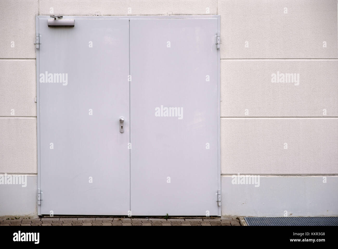 A side wall of a shopping centre with an emergency exit. Stock Photo
