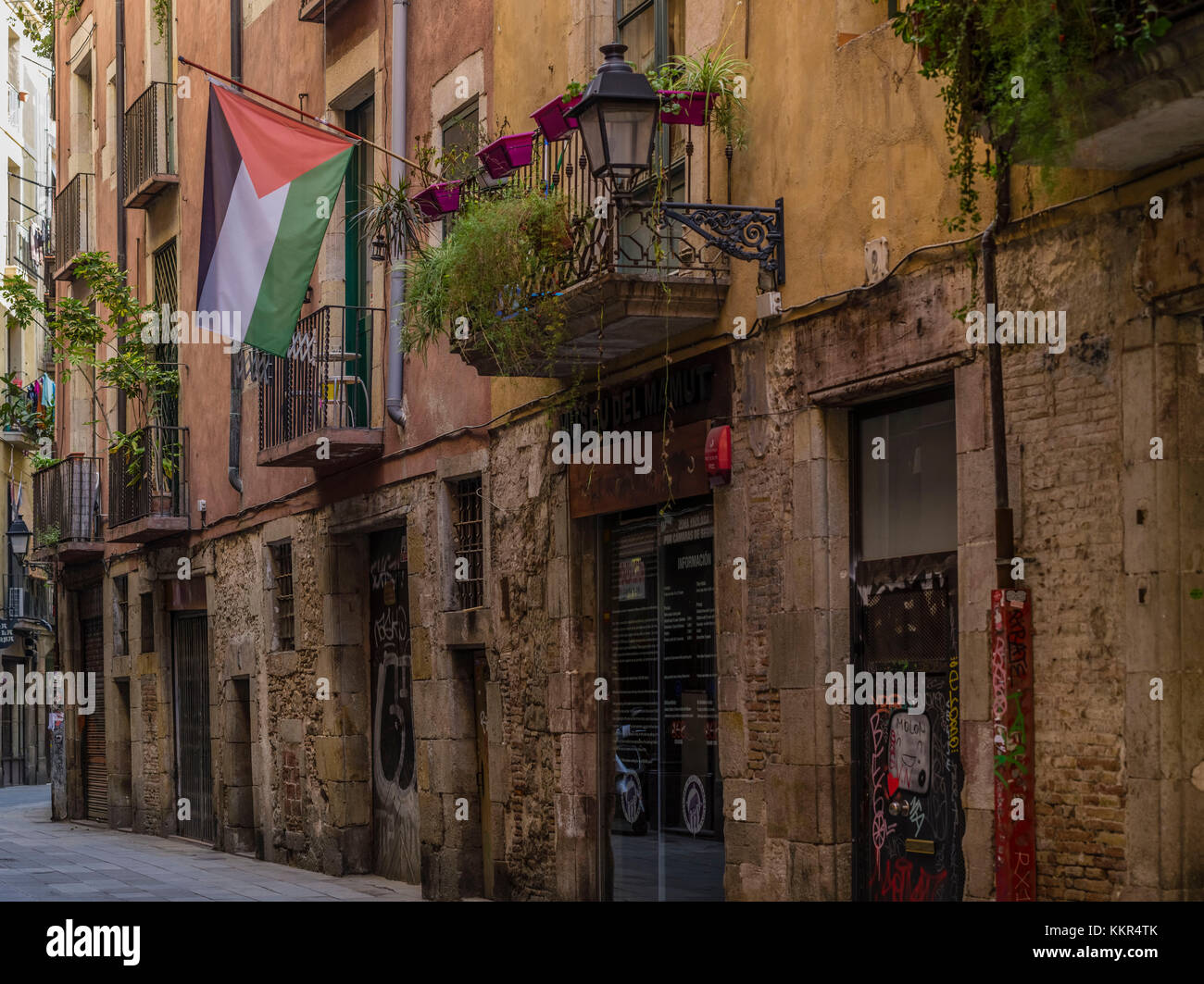 Old town lane in Barcelona with Palestinian flag Stock Photo