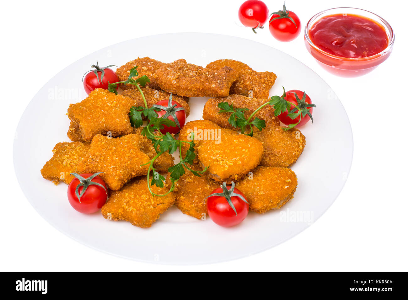 Nuggets of different shapes with ketchup on white background Stock