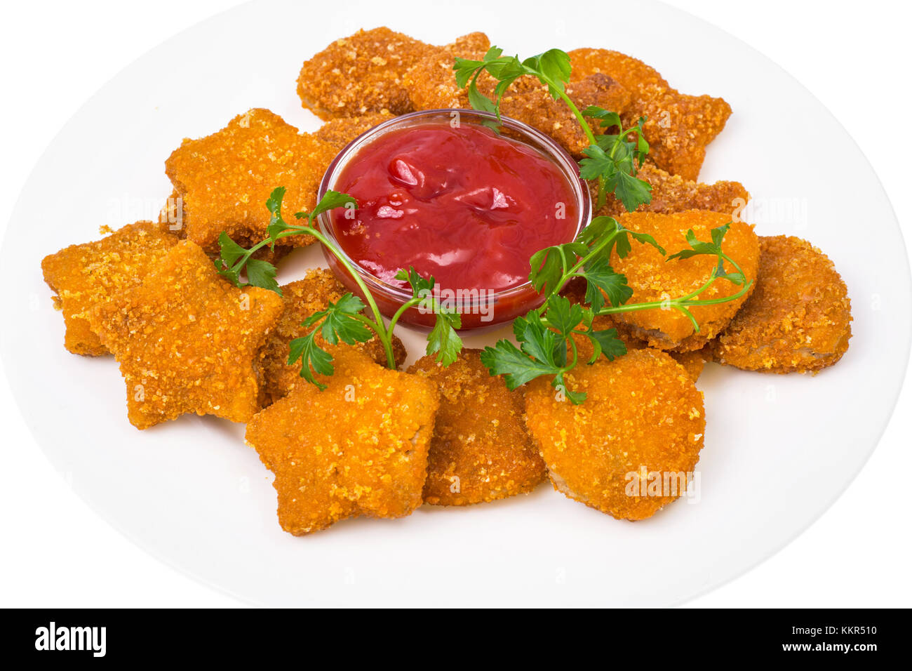 Nuggets of different shapes with ketchup on white background Stock