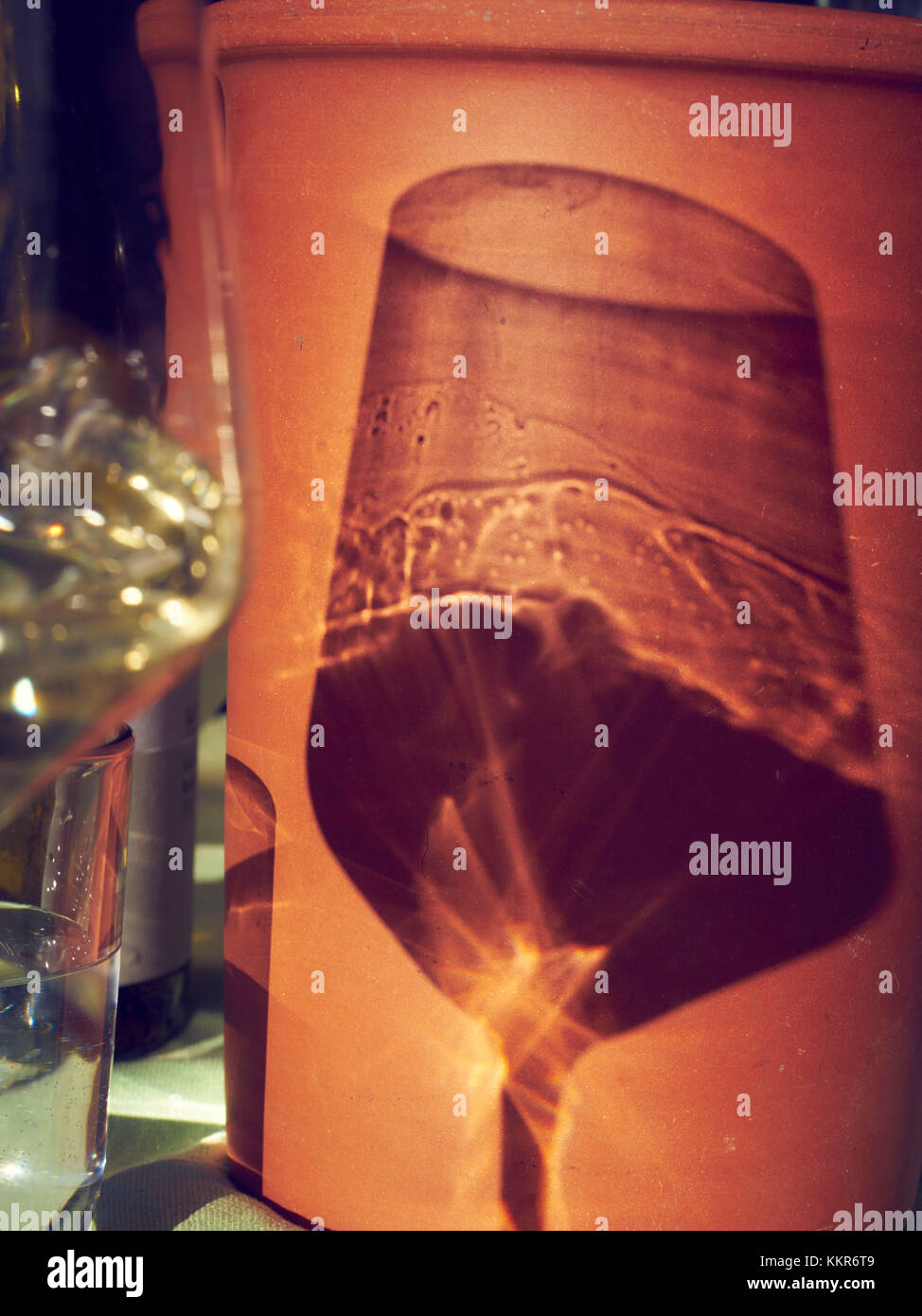 Wineglass and wine cooler on table, shadow Stock Photo