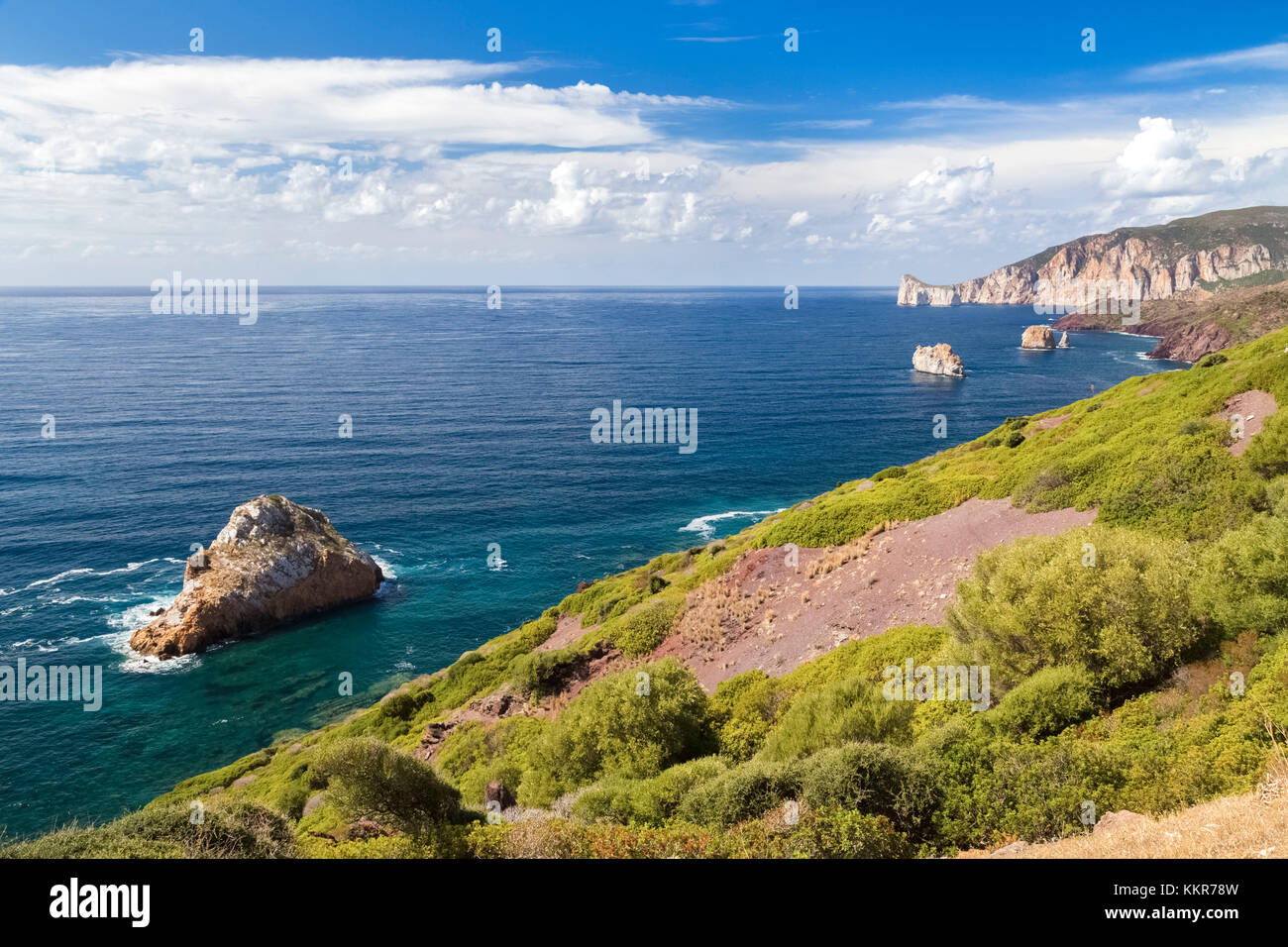 View of the coast near Masua, in the distance the Pan di Zucchero reef. Masua, Sulcis-iglesiente, Iglesias, Sardinia, Italy. Stock Photo