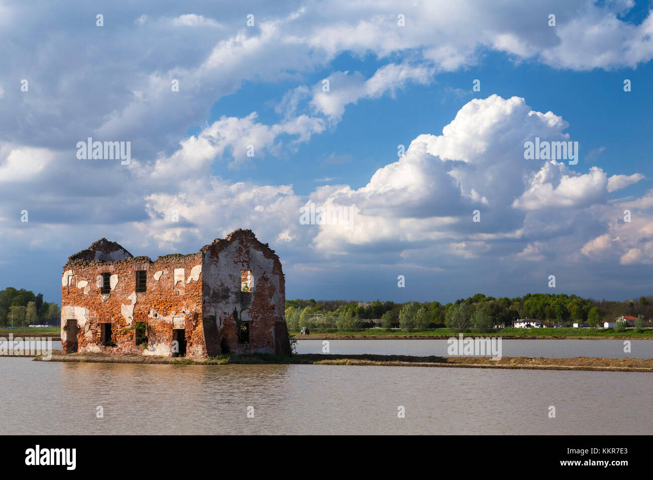 Clouds over a decayed house between rice fields, Casaleggio di Novara, Novara, Piedmont, Italy. Stock Photo