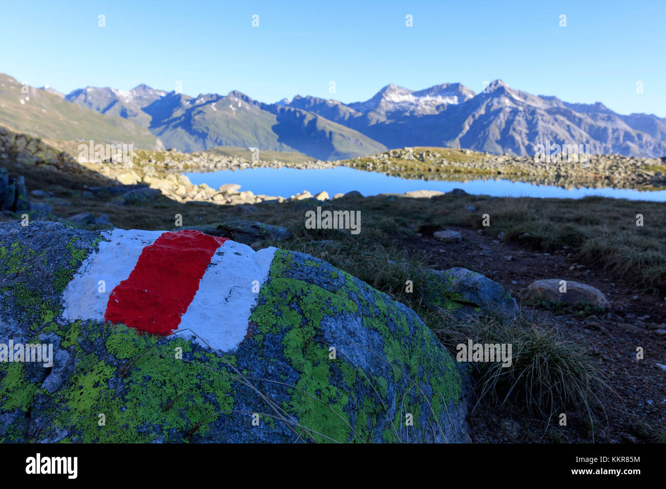 Signage of hiking trails on rocks, Lake Bergsee, Spluga Valley, Spluga Pass, province of Sondrio, Lombardy, Valtellina, Italy Stock Photo