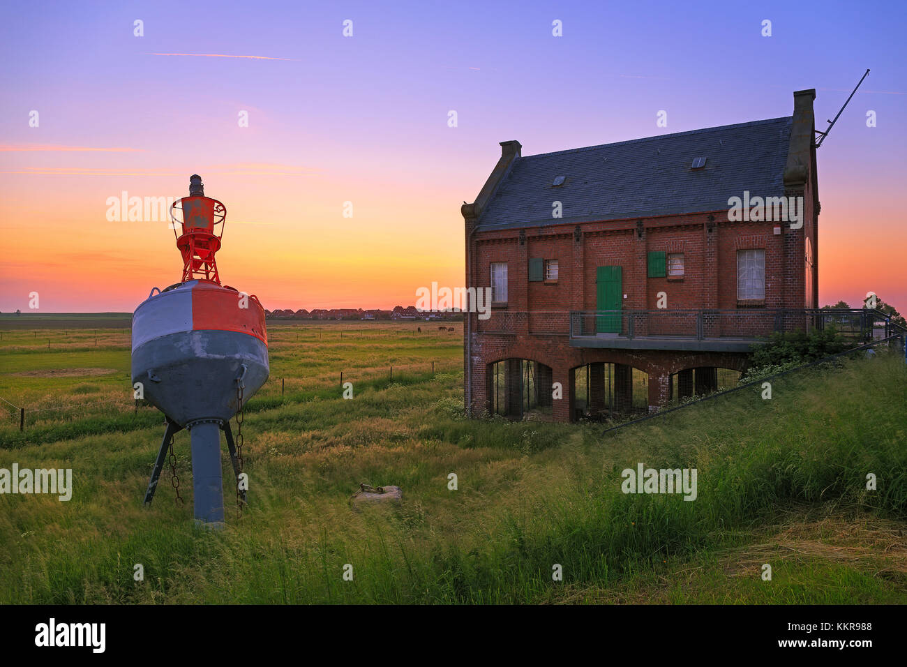A buoy in front of a building in Harlesiel, East Frisia Stock Photo