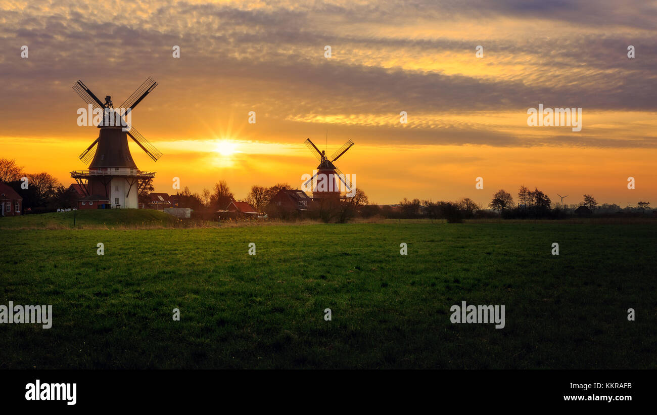 The famous twin mills of Greetsiel, East Frisia at sunrise Stock Photo