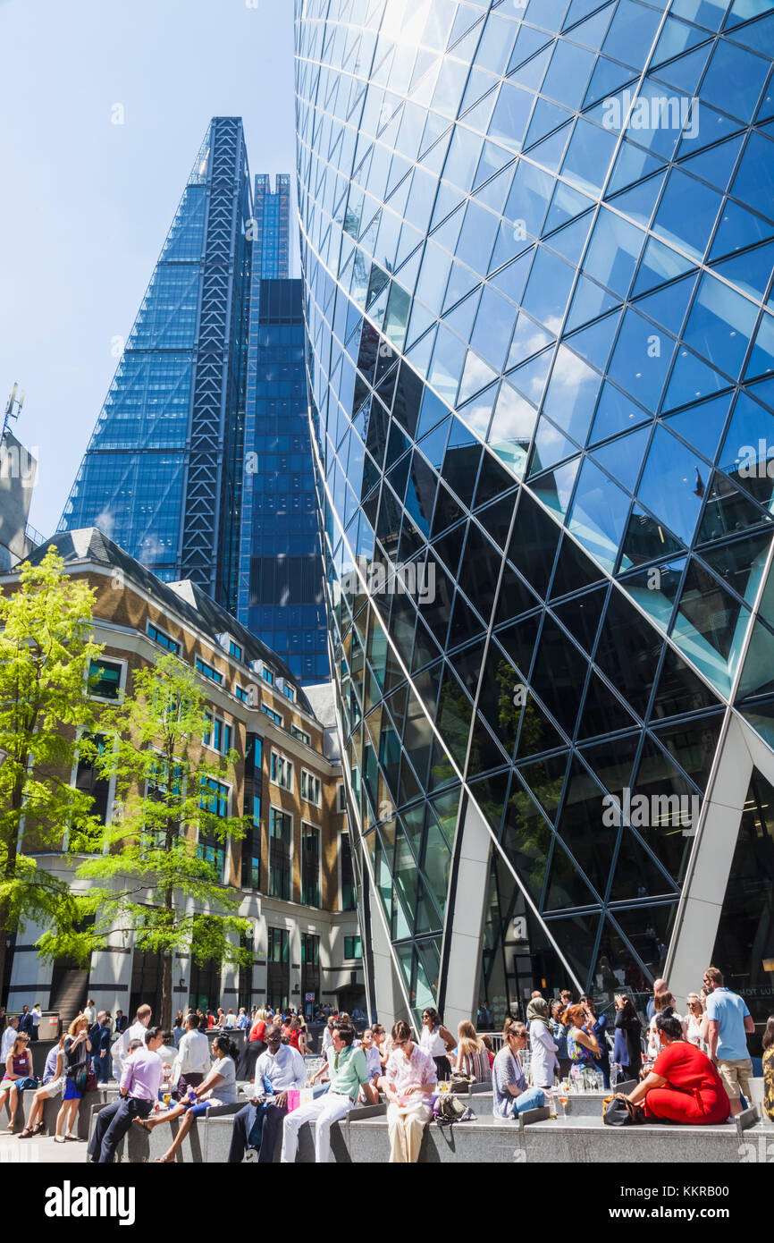 England, London, City of London, Office Workers Relaxing at the Base of 30 St Mary Axe aka The Gherkin Stock Photo