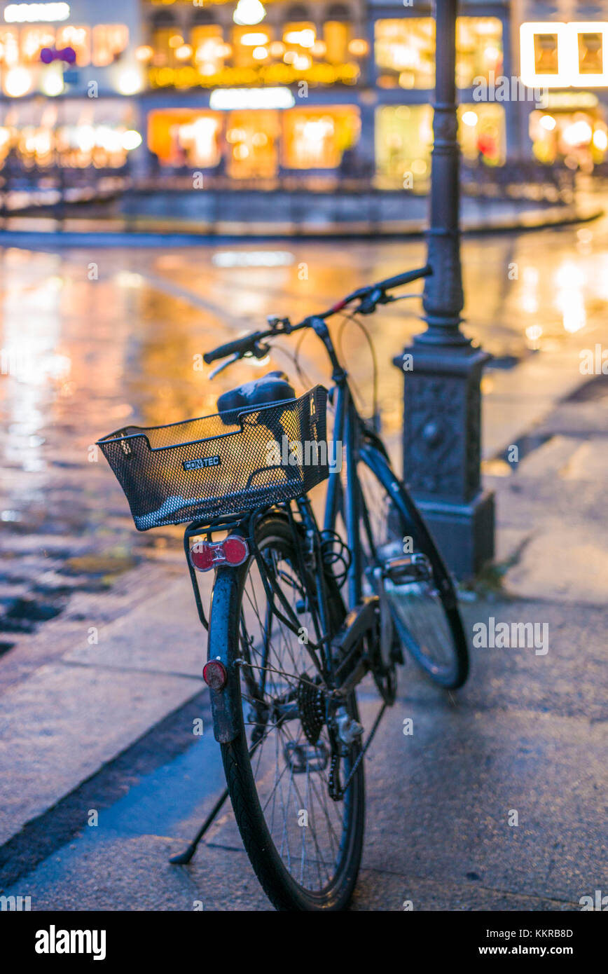 Germany, Bavaria, Munich, Theatiner Strasse shopping district, bicycle, evening Stock Photo