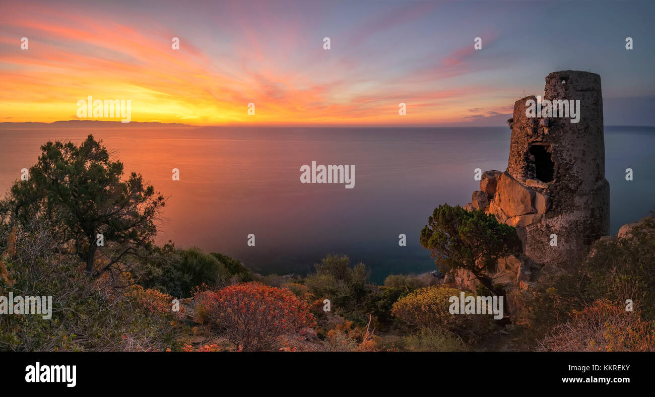 ancient devil's tower at sunrise, Sud Sardinia, Italy. This sighting tower was built in 1639 by the Crown of Spain, and is made of volcanic rock material, andesite and friezes in calcareous sandstone Stock Photo