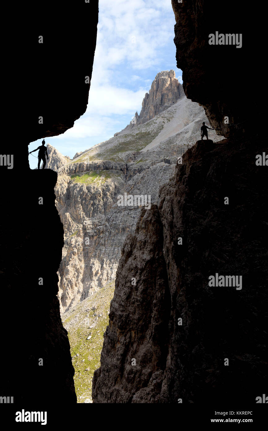 Italy, South Tyrol, Sexten, Hochpustertal, Bolzano. Hiker in silhouette on the Alpinisteig or Strada degli Alpini via ferrata, Sexten Dolomites Stock Photo