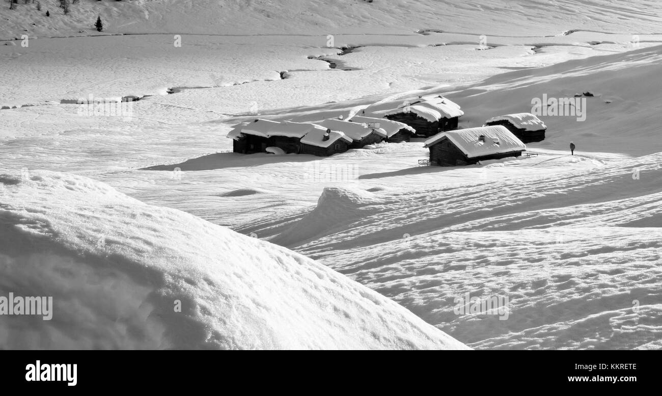 Huts snowcapped during winter. Rezzalo valley, Valtellina - Stelvio National Park, Lombardy, Italy Stock Photo