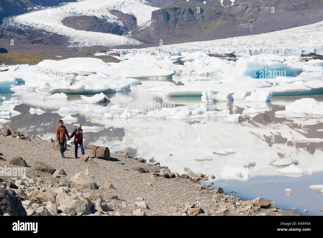 Tourists walking along Fjallsarlon Iceberg Lagoon, austurland, eastern Iceland, iceland Stock Photo