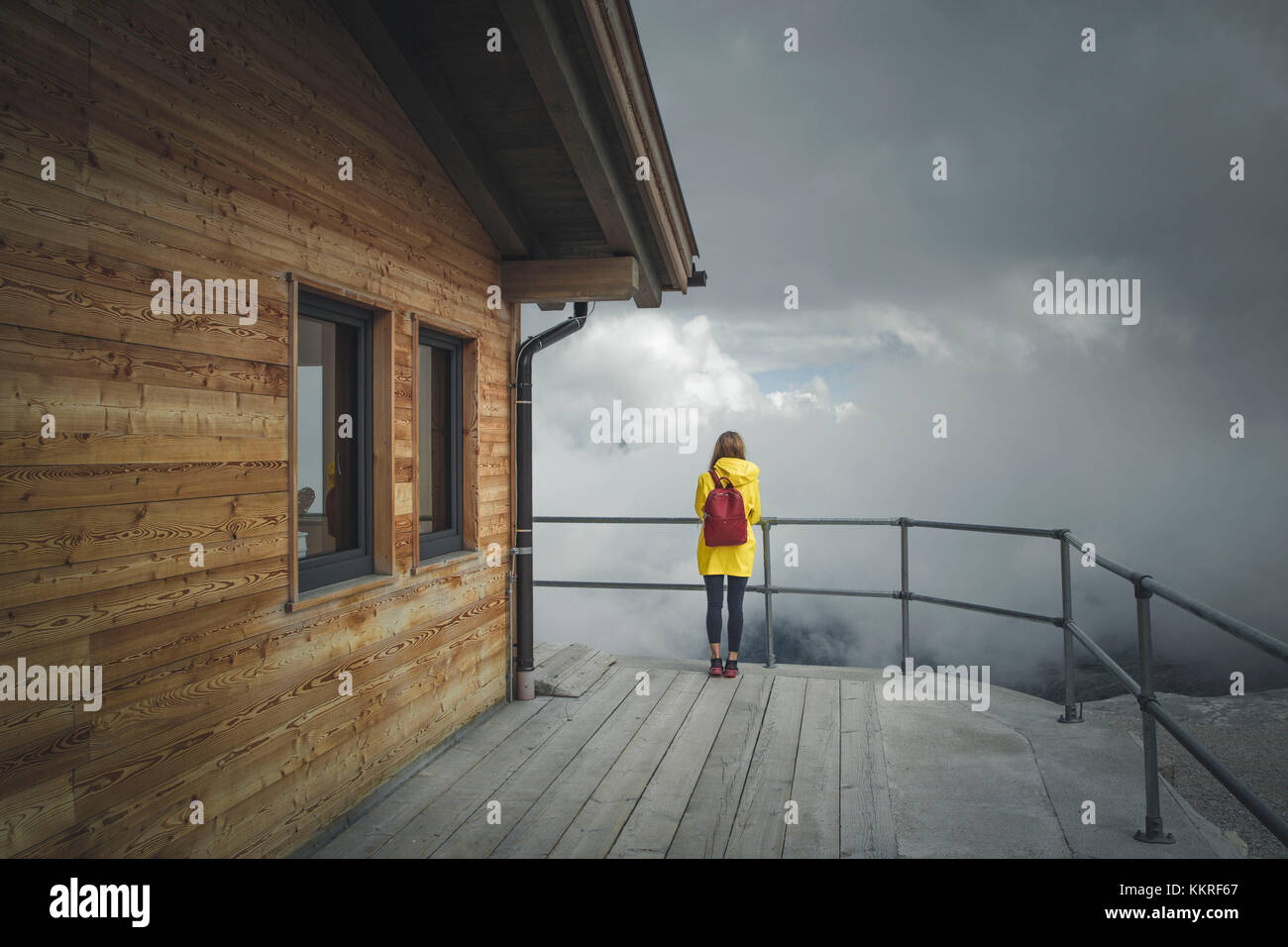 A girl with yellow raincoat on the top of Zugspitze glacier. Garmisch-Partenkirchen, Bavarian Alps, Germany. Stock Photo