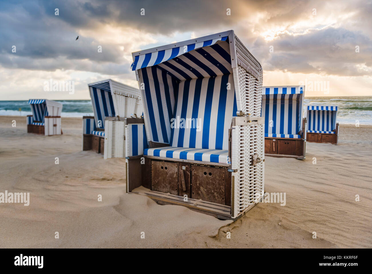 Kampen, Sylt island, North Frisia, Schleswig-Holstein, Germany. Strandkorbs on the beach at sunset. Stock Photo