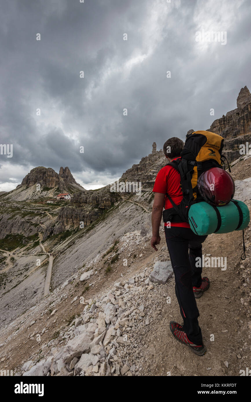 Sesto/Sexten, Dolomites, South Tyrol, province of Bolzano, Italy. Climber on the via ferrata 'Path of Peace' to the mountain of Monte Paterno Stock Photo
