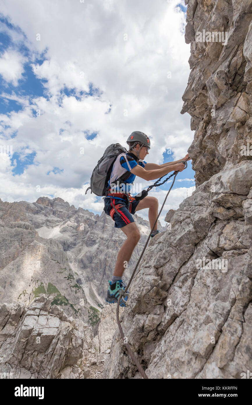 Climber on the via ferrata Cengia Gabriella, Popera group, Giralba, Sexten Dolomites, Belluno, Veneto, Italy Stock Photo