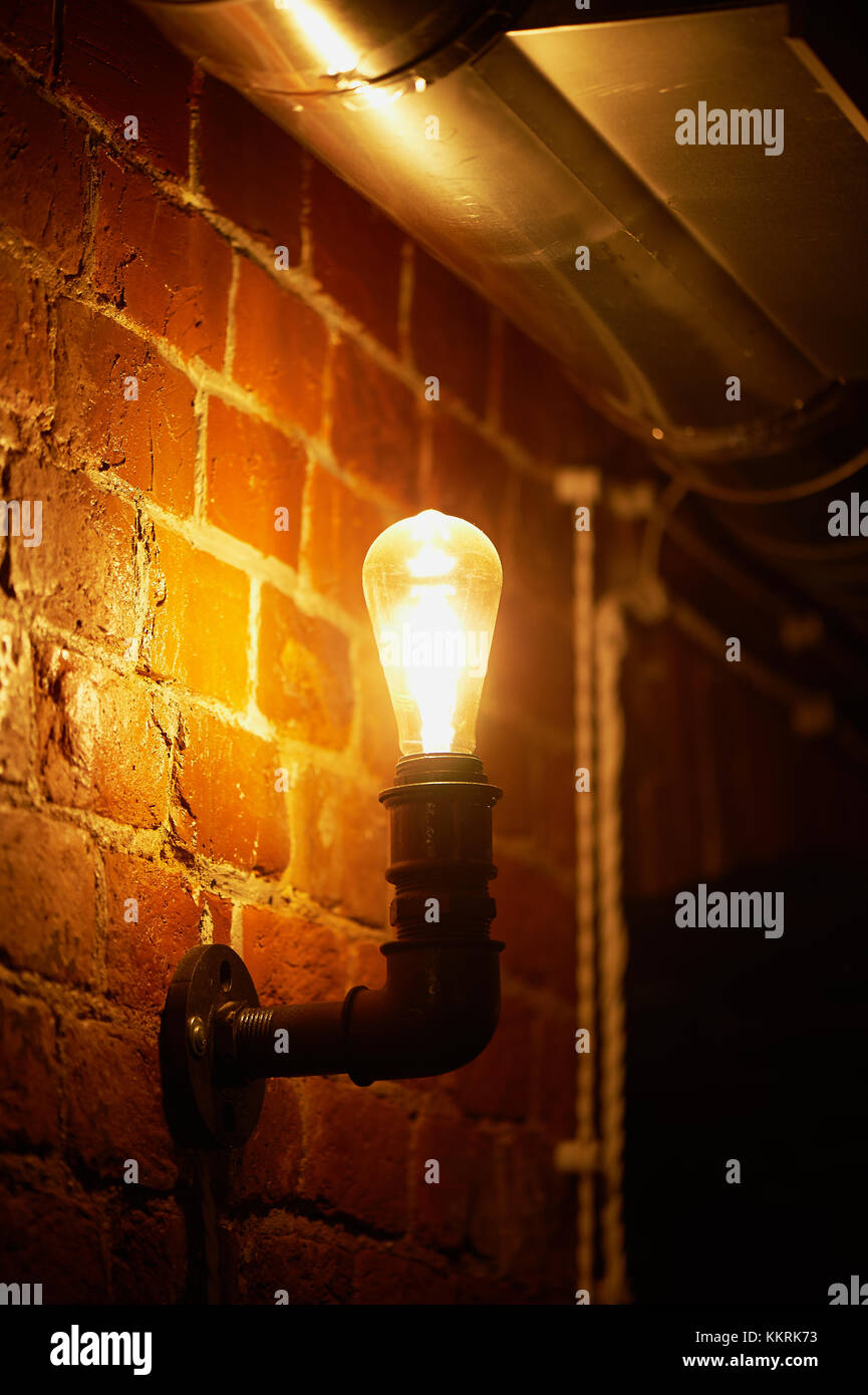 Edison light bulb hanging on a long wire. Cozy warm yellow light.Retro