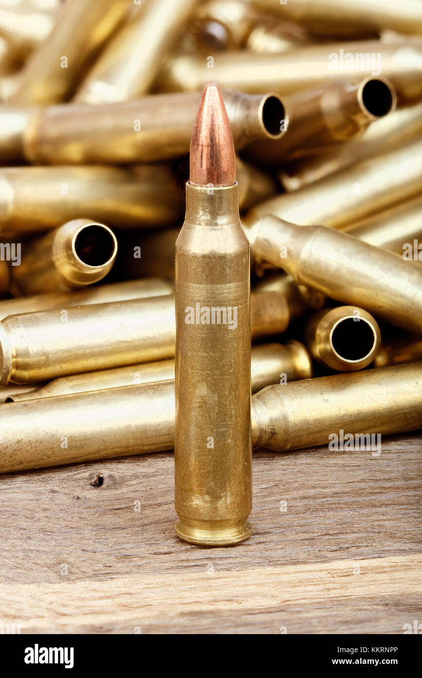 Close-up photo of bullet on the wooden table. Stock Photo