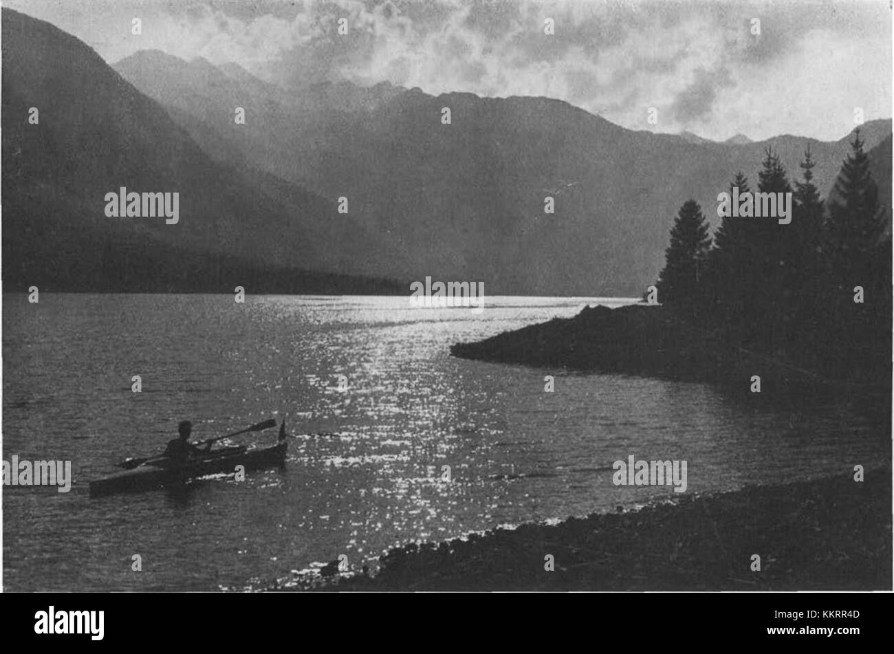 This historical photograph of Bohinj Lake in Slovenia from 1934 showcases the lake's natural beauty and serene environment, a popular destination for visitors seeking tranquility and outdoor recreation. Stock Photo
