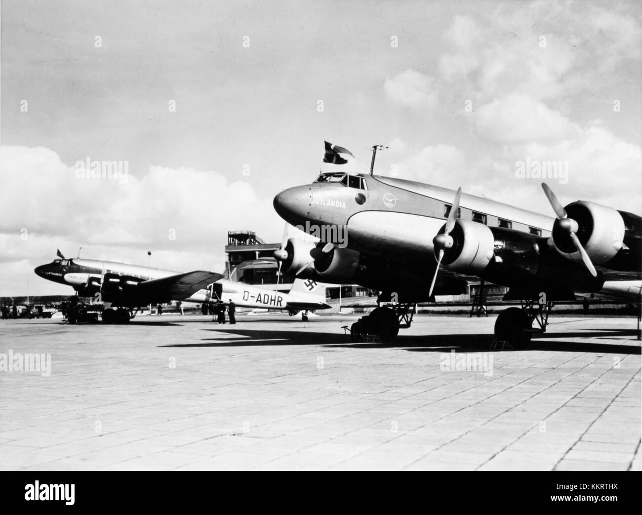 This image shows two Focke-Wulf Fw 200 aircrafts: the DDL Fw 200 and DLH Fw 200, both at the airport. These aircraft were significant in the history of aviation, particularly during the early to mid-20th century. Stock Photo