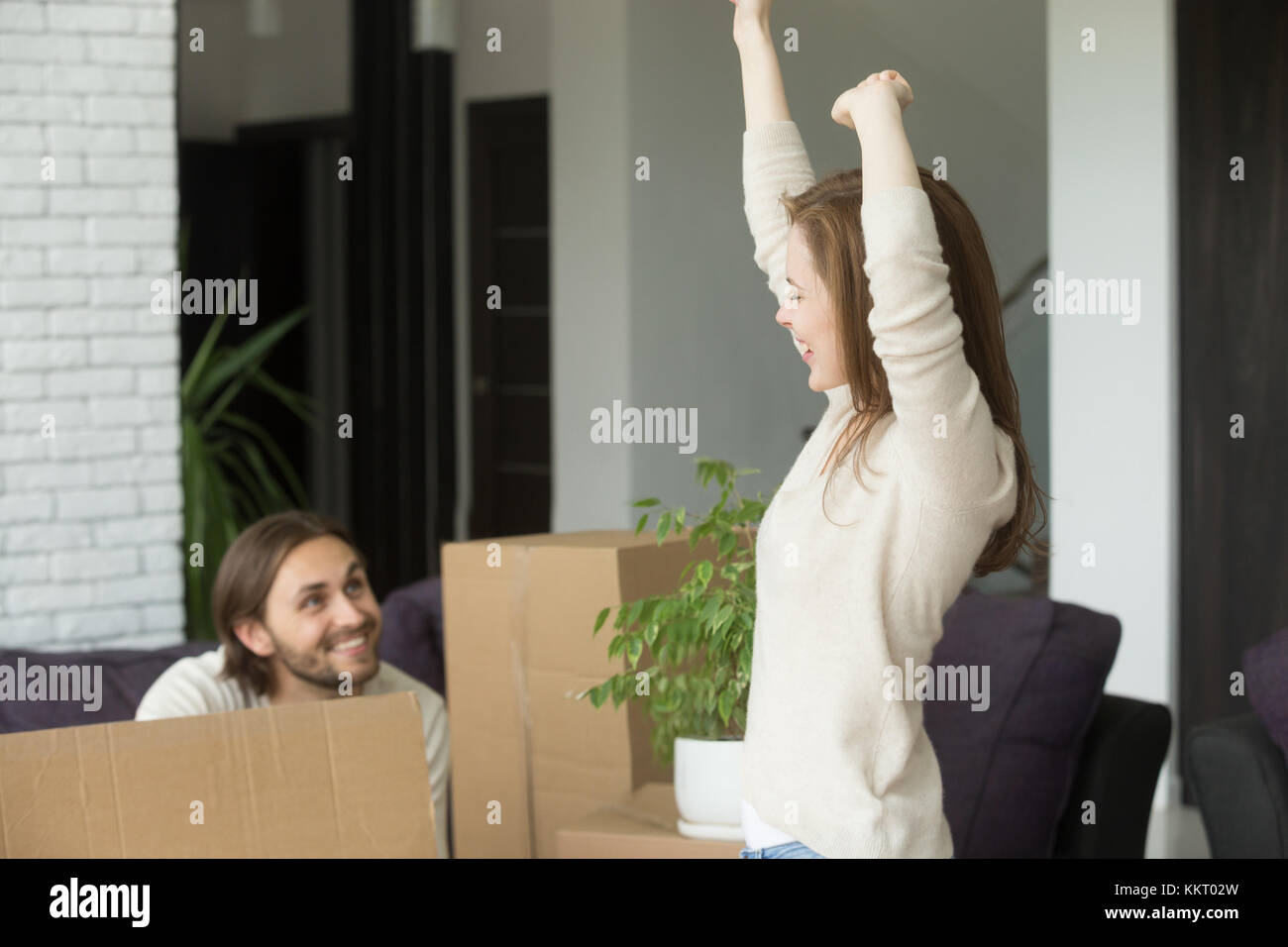 Young couple feeling happy celebrating moving in new own home Stock Photo