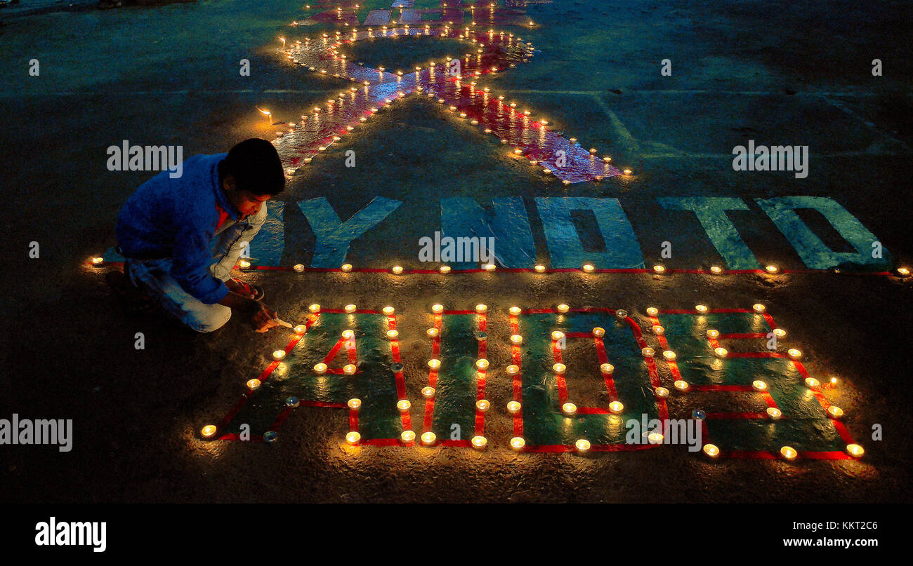 An Indian child light candles on the occasion of World AIDS Day & an