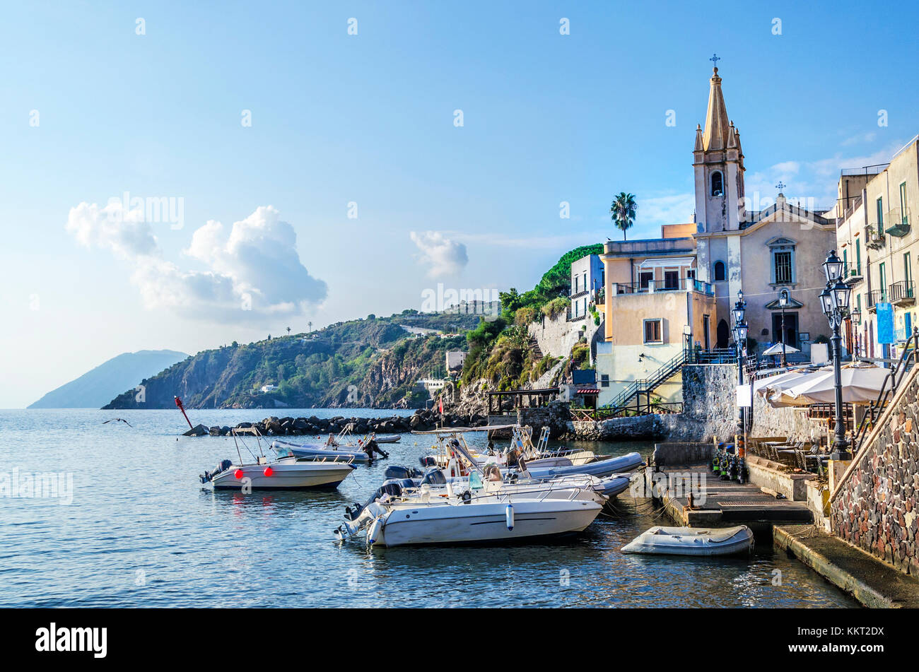 Sports boats are appreciated its berth and the parish of San Giussepe of the year fifteen hundred and forty-five on the island of lipari italy Stock Photo