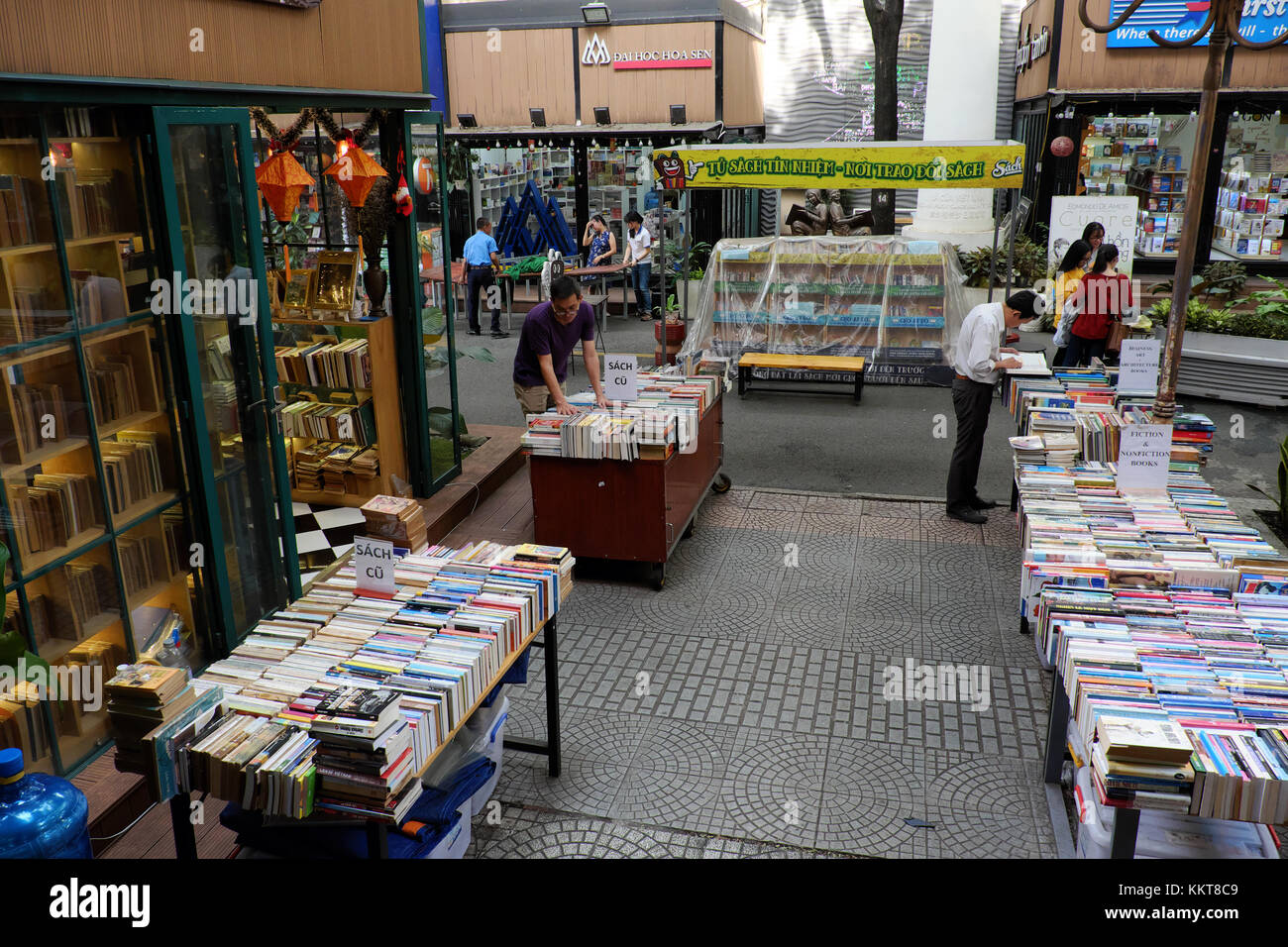 HO CHI MINH, VIET NAm, Reader reading book at bookstore, publishing company show colorful books outdoor of shop, reading lost in modern society Stock Photo