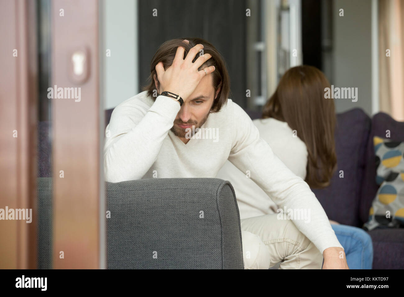 Upset man thinking of bad relationships problems, couple after q Stock Photo