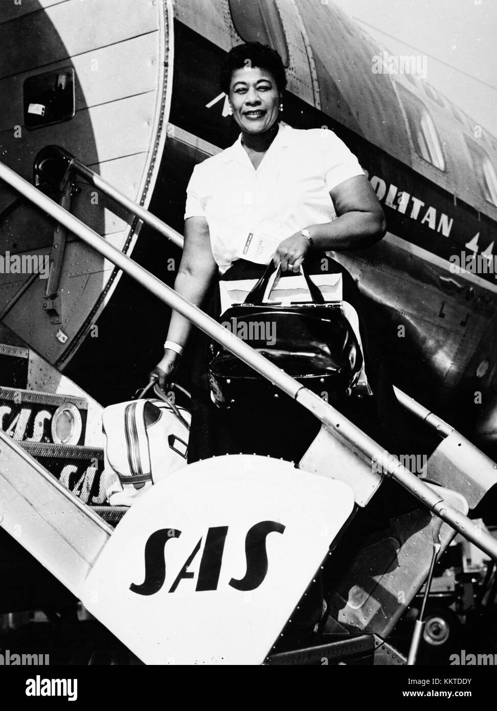 Ella Fitzgerald, the famous jazz singer, is captured disembarking from a Convair 440 Metropolitan aircraft. This image highlights her significant role in 20th-century music and her travel as an international performer. Stock Photo