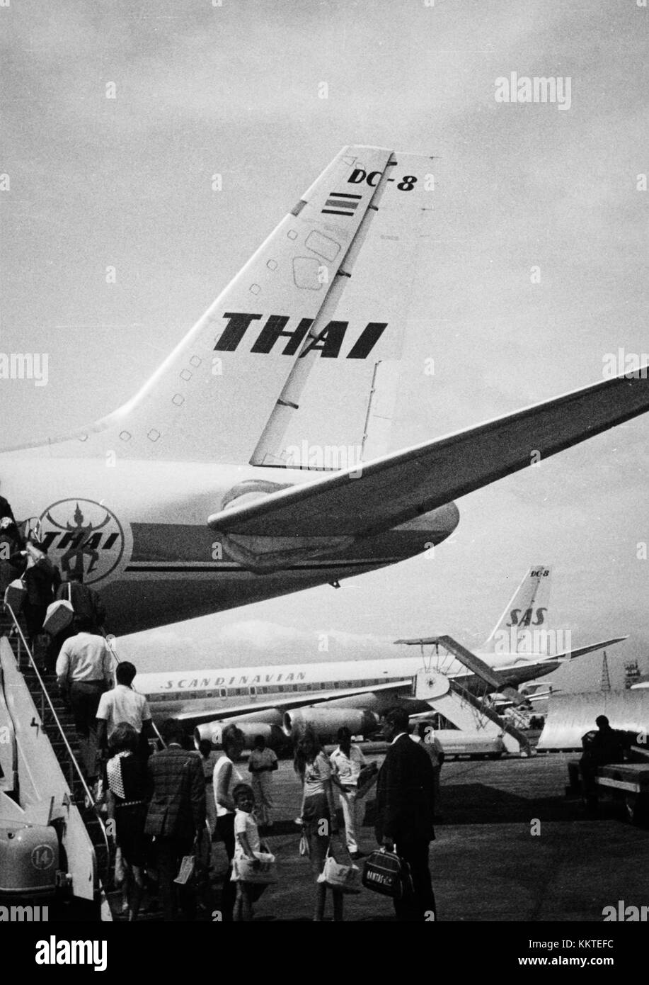 In 1960, passengers boarded an SAS DC-8 aircraft at Don Muang Airport (DMK), Bangkok, Thailand. This image captures the bustling atmosphere of the airport as travelers prepared for their flight, marking a significant moment in aviation history as jet airliners were becoming more widespread. Stock Photo
