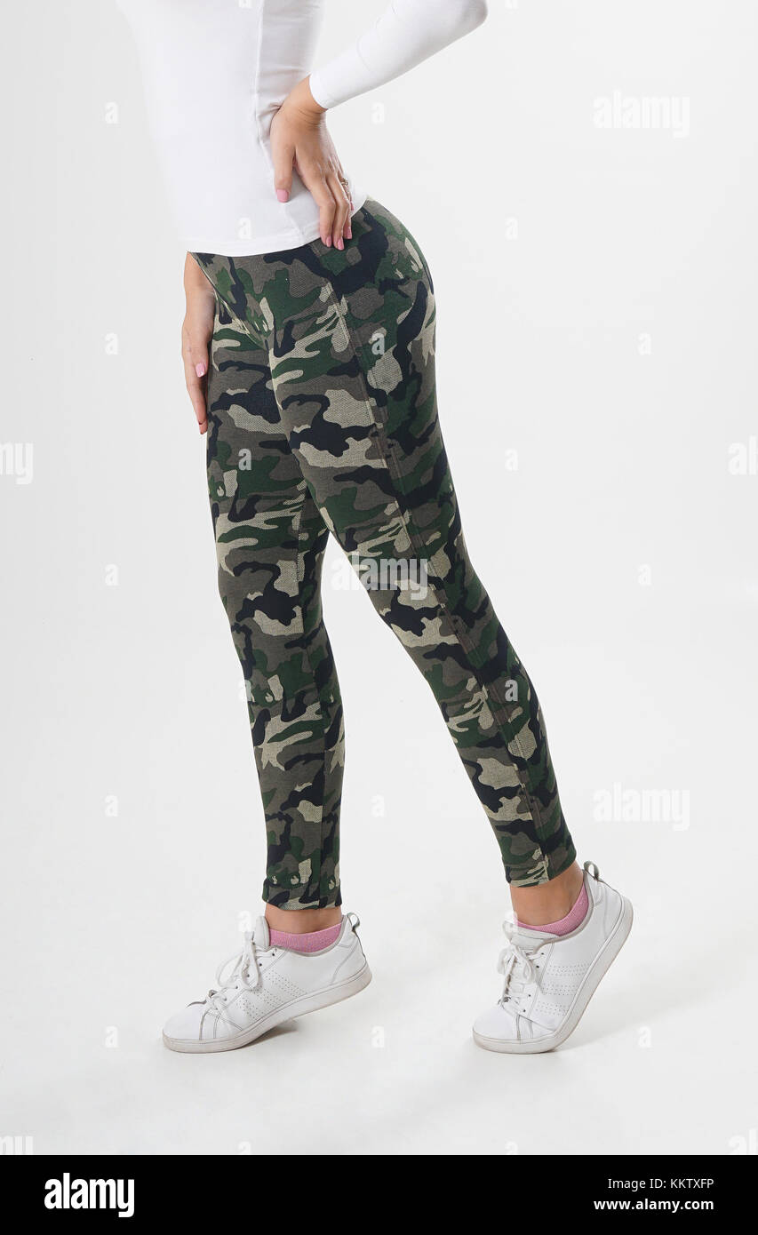 Girl in camouflage leggings, white blouse and white sneakers Stock Photo -  Alamy
