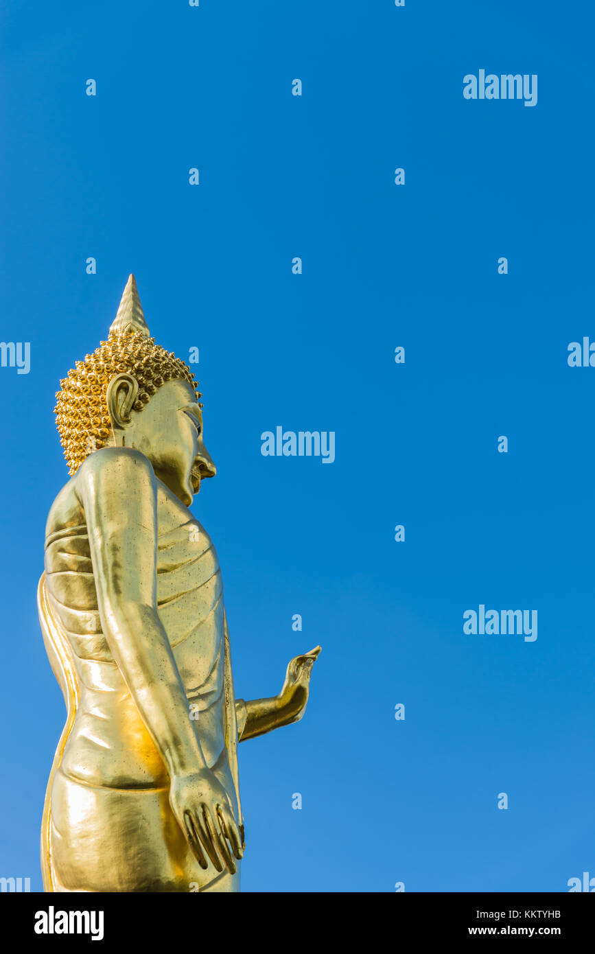 Stand Buddha statue with Blue sky in Wat Phra That Kao Noi Nan Thailand ...