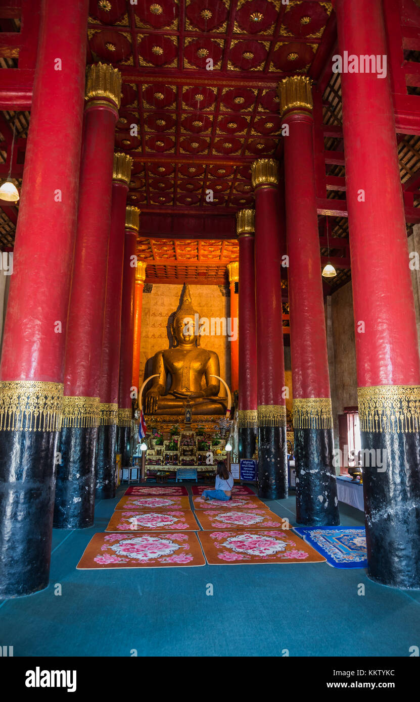 Golden Buddha statue with Red column in Wat Phra That Chang Kham is one ...
