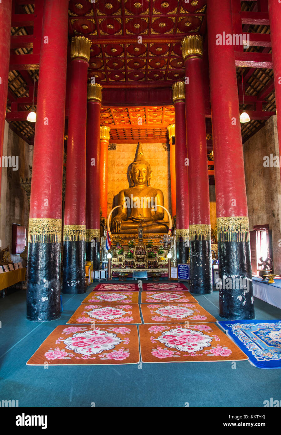 Golden Buddha statue with Red column in Wat Phra That Chang Kham is one ...
