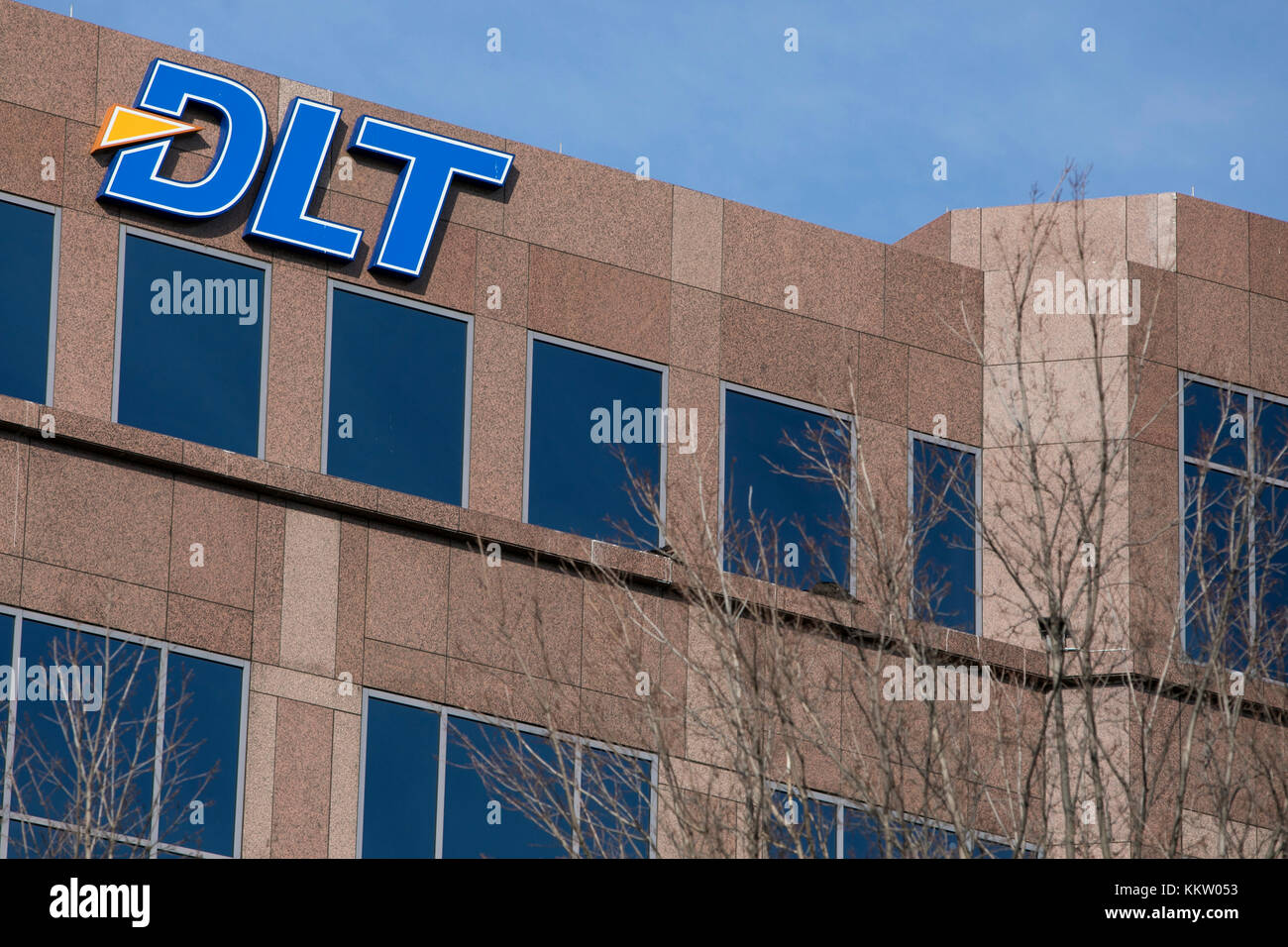A logo sign outside of a facility occupied by DLT Solutions in Herndon
