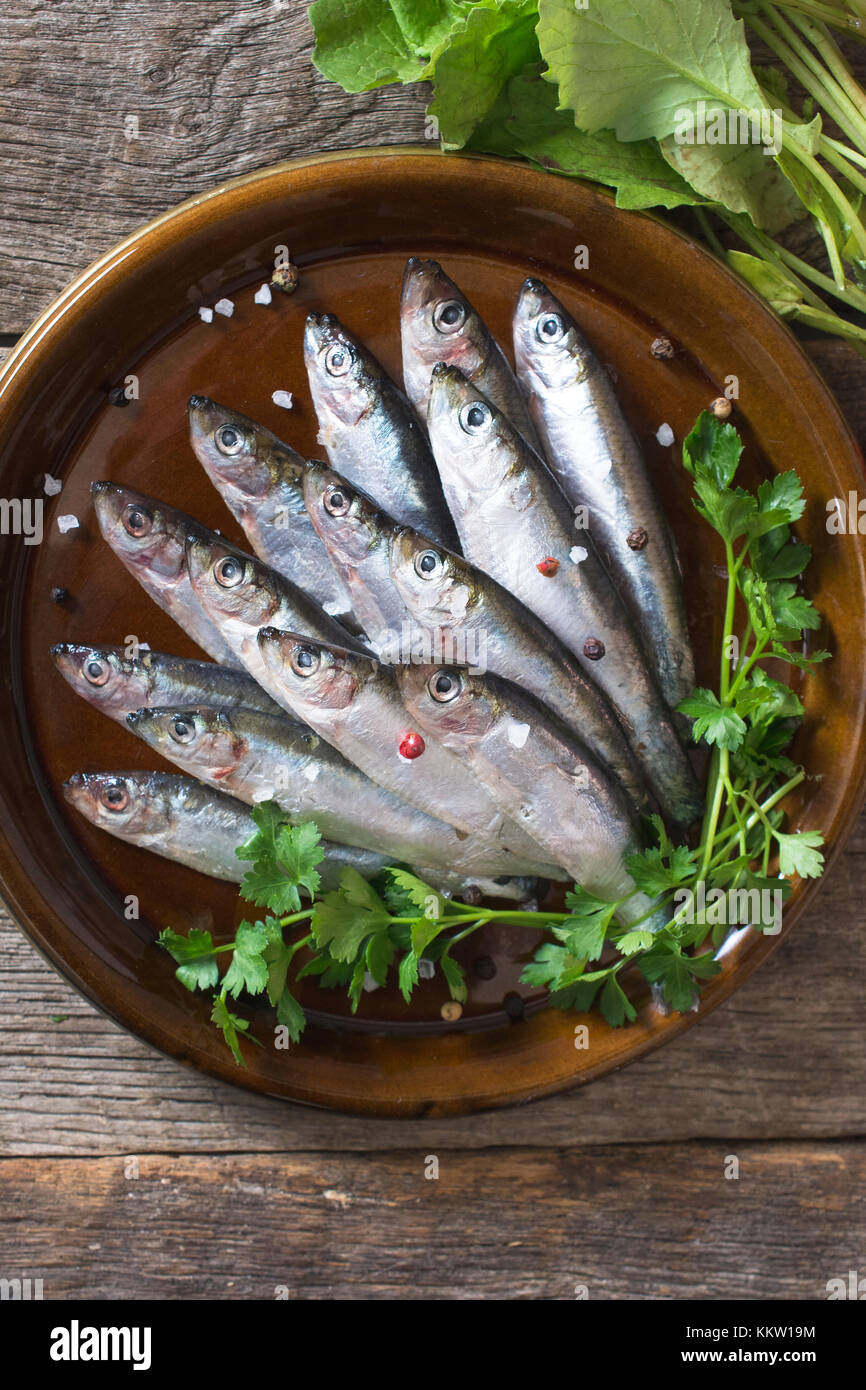 Raw smelt fishes in the plate from above Stock Photo