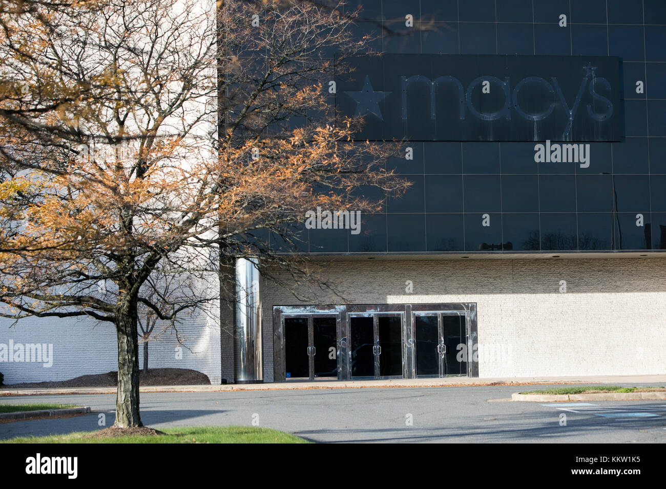 The outline of a Macy's logo sign outside of a now closed retail store