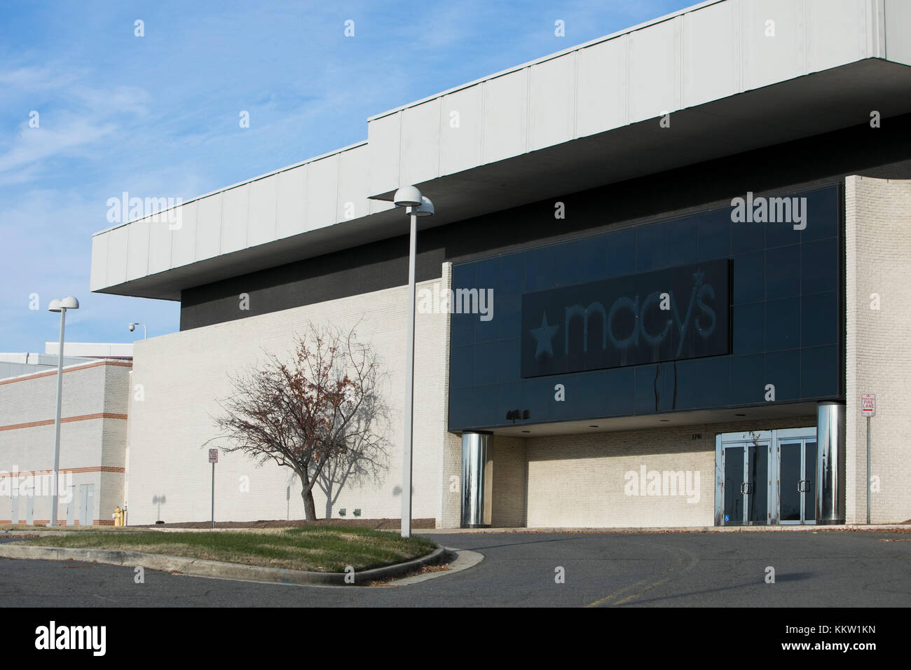 The outline of a Macy's logo sign outside of a now closed retail store