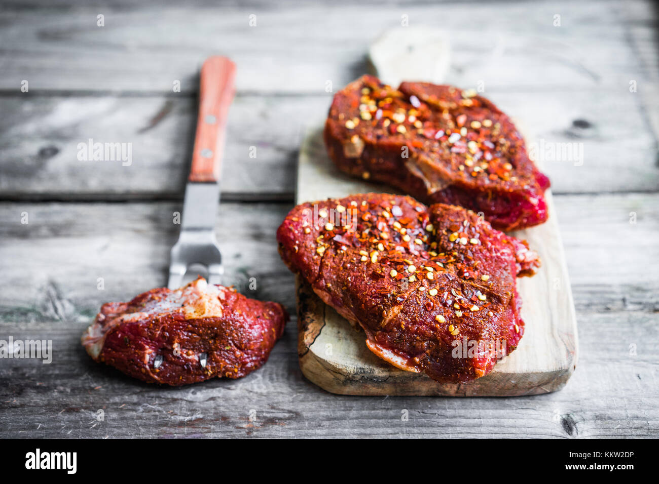 Raw meat on wooden background Stock Photo