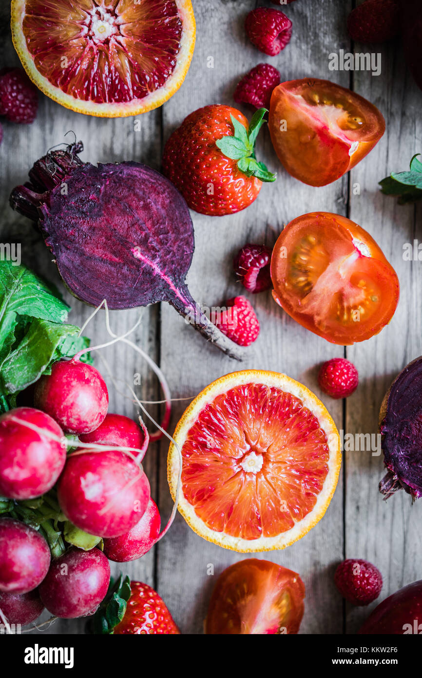 Red fruits and vegetables on wooden background Stock Photo - Alamy