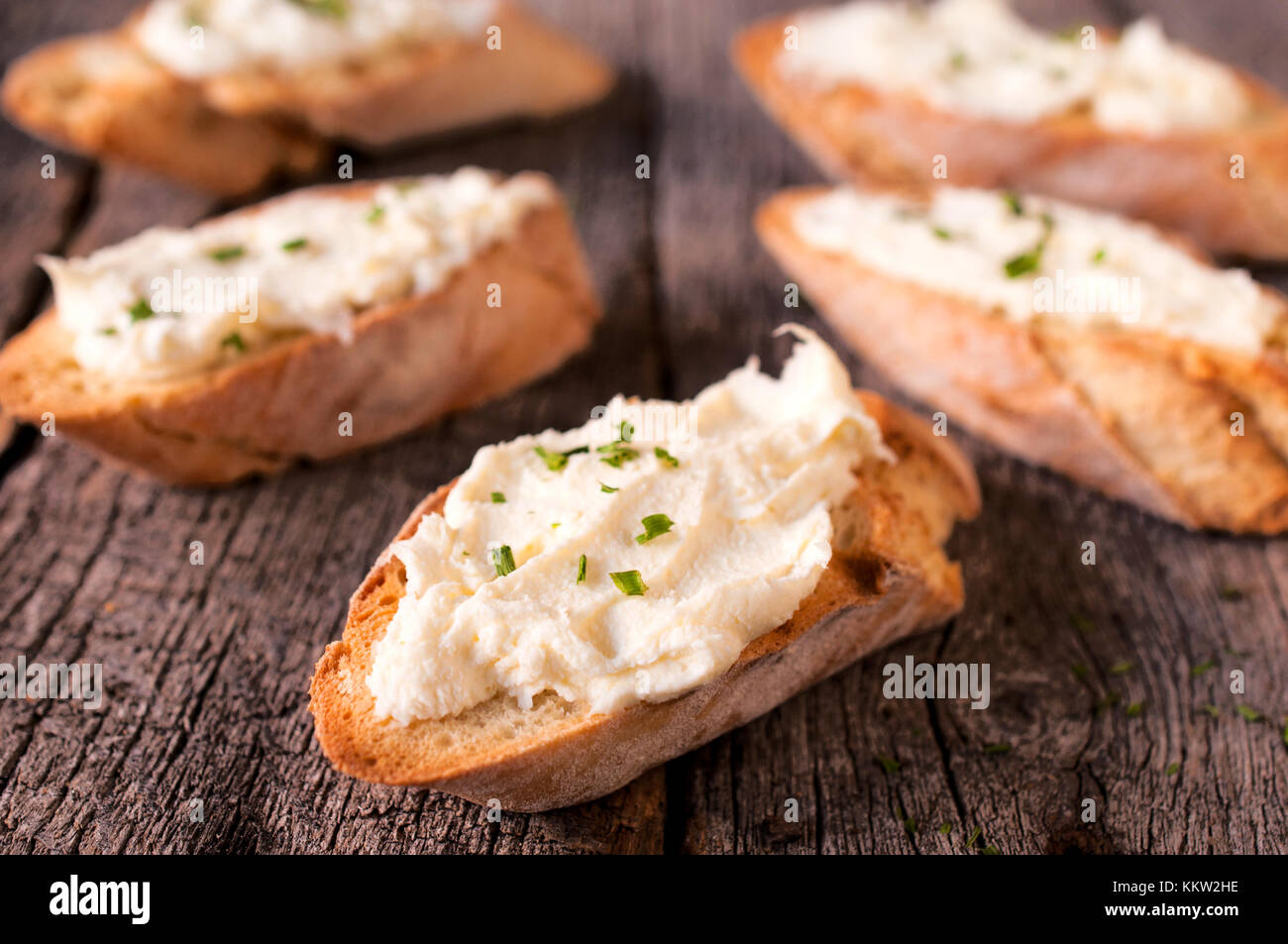 Selective focus in the middle of front bruschetta with cheese cream Stock Photo