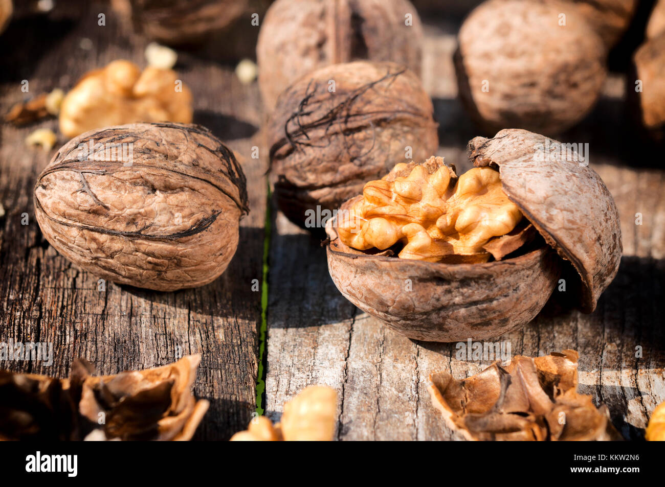 Selective focus on the walnut in shell on wooden table Stock Photo