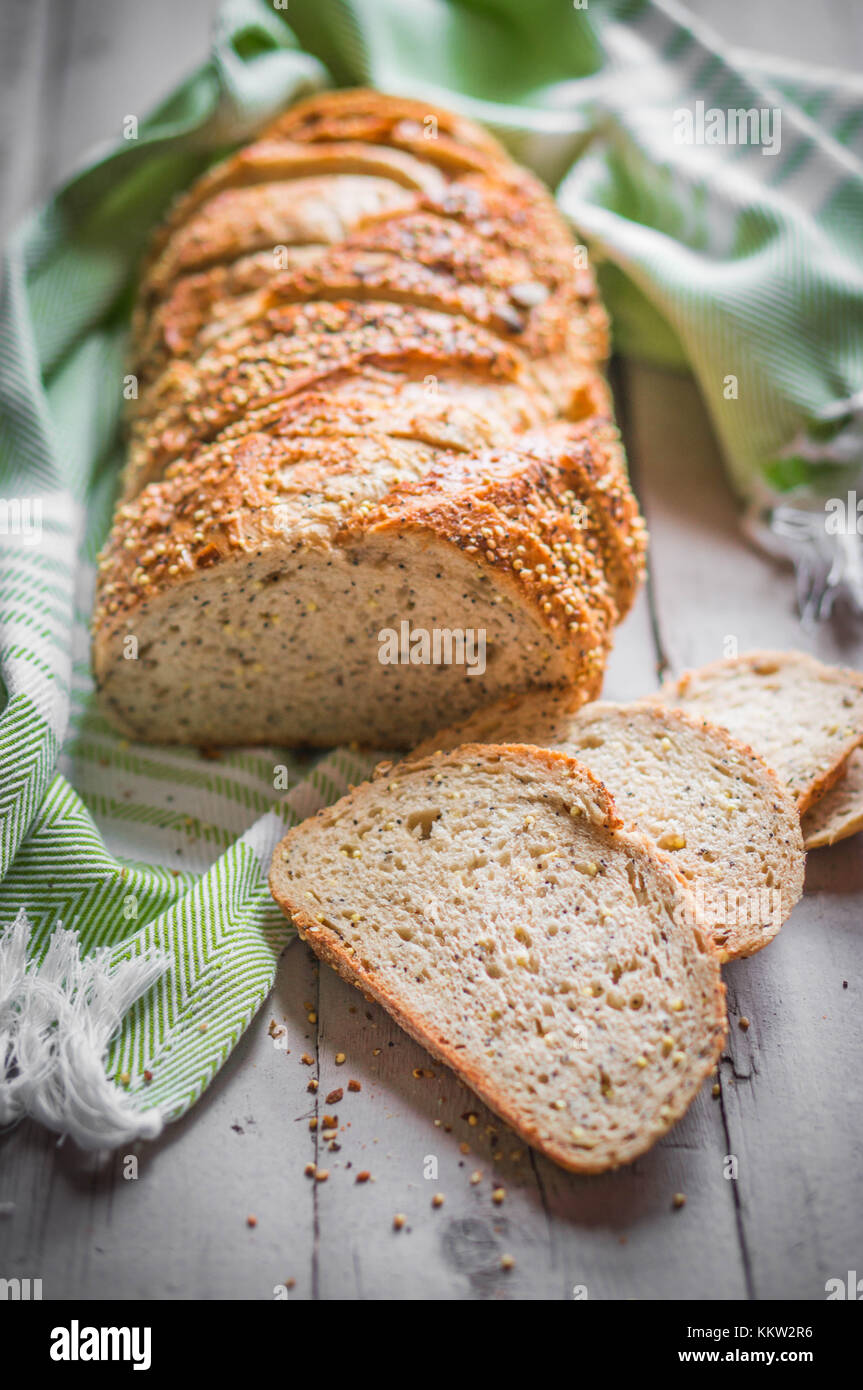 Sliced Loaf Of Seeded Bread On Wooden Background Stock Photo