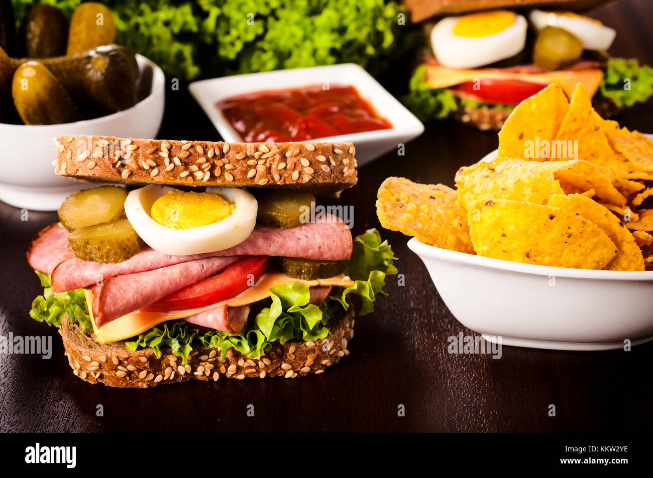 Toast sandwich and tortilla chips on the wooden table Stock Photo