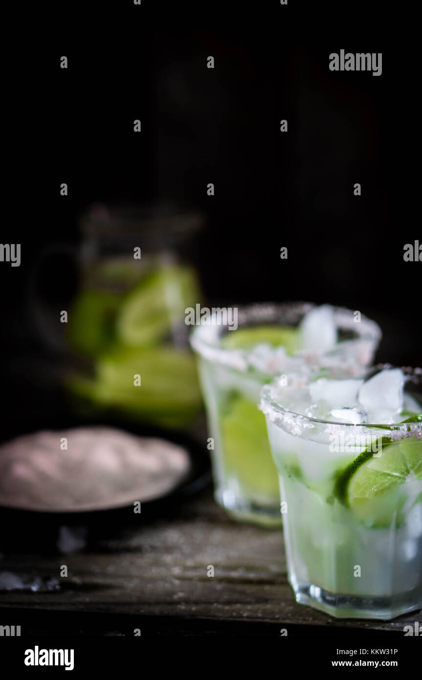 Water With Ice And Limes On Rustic Background Stock Photo